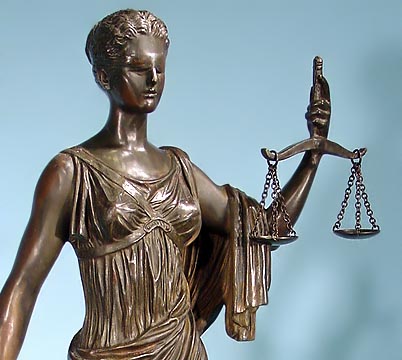 Blindfolded Justice holding a balance in the left hand